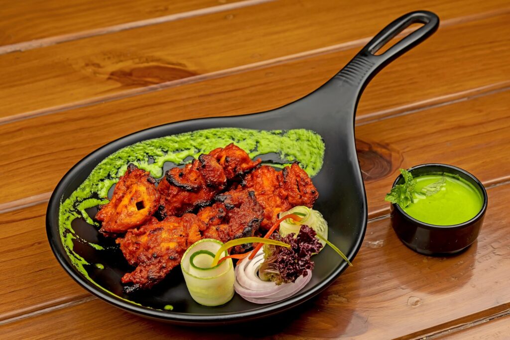 Smoky tandoori chicken on a sizzling platter